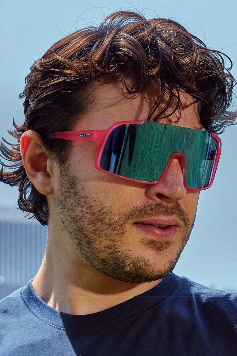 Homem usando óculos de sol SPORTBR Goodr rosa com lentes espelhadas azuis polarizadas para corrida ao ar livre