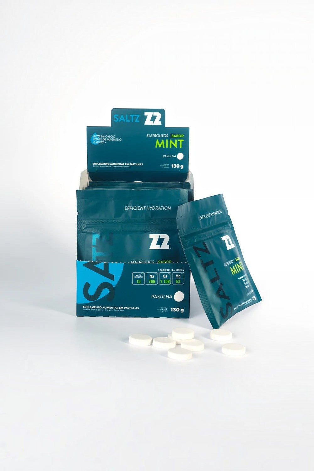 Caixa de SPORTBR Saltz Z2 com 10 sachês de pastilhas de eletrólitos sabor mint e pastilhas brancas espalhadas