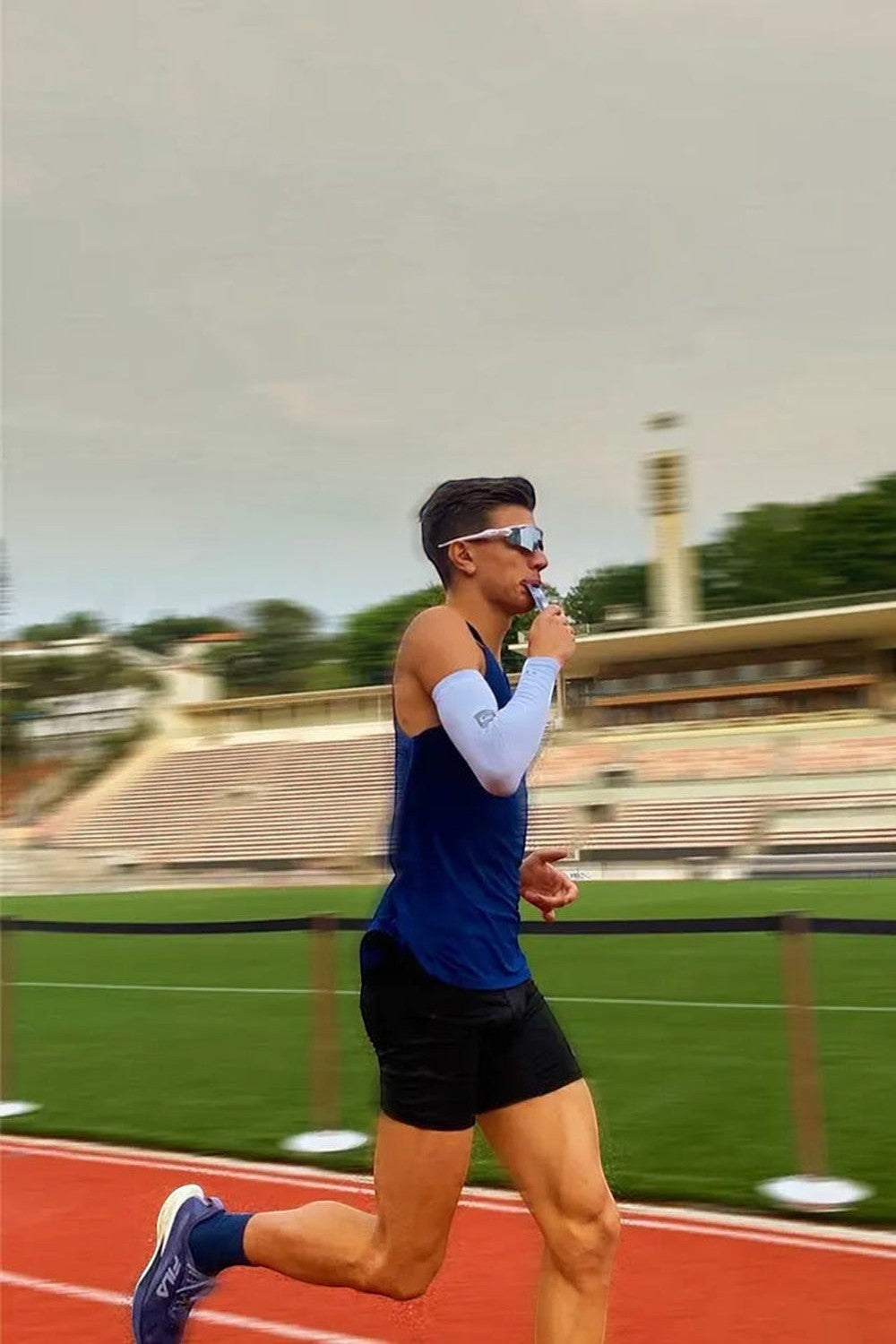 Atleta da SPORTBR correndo em pista de atletismo consumindo sachê de Hidro Gel Tech Dobro com cafeína