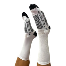 Meia cano alto branca da Steigen com detalhes em preto e cinza, ideal para corrida e esportes.