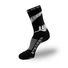 Meia cano alto preta Steigen Nova Zelândia com estampa de samambaia branca e logo da marca. Feita em nylon e lycra.