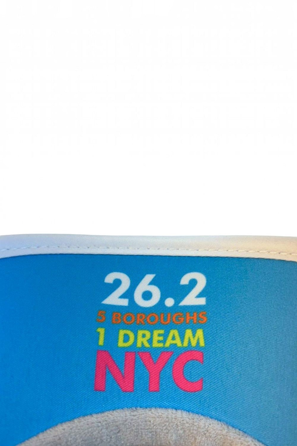 Viseira SPORTBR branca com estampa azul 26.2 NYC, ideal para corrida com tecido tecnológico de alta absorção.